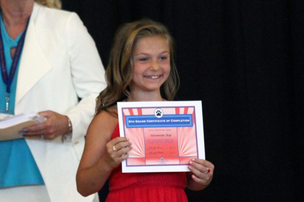 Girl with moving up certificate