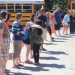 CMS staff wave and give out hugs as students leave for summer break