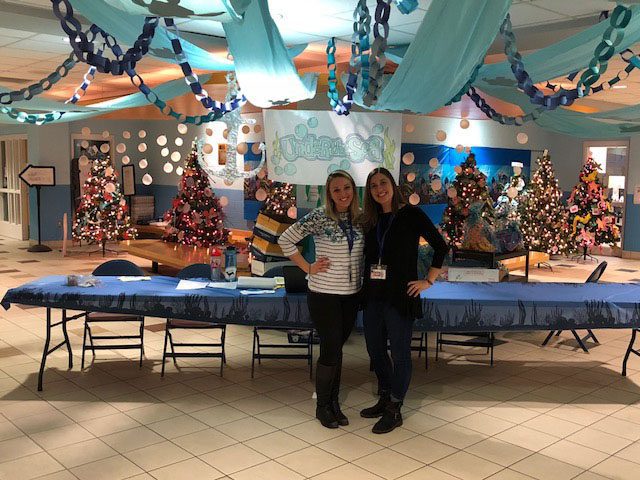 Two teachers pose with undersea decorations
