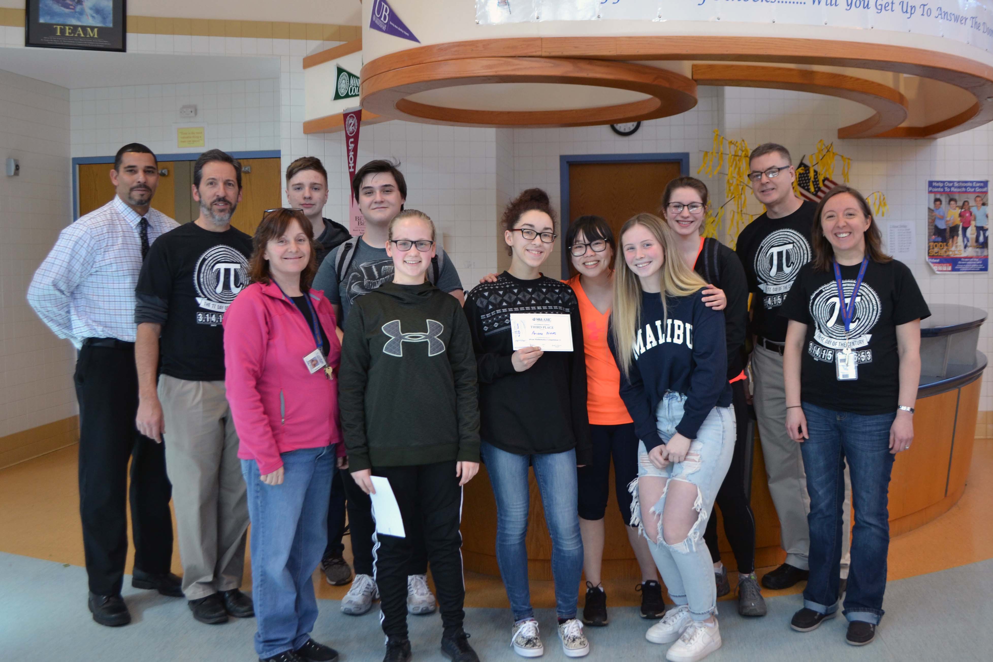 Catskills top finishers and math facuty pose for picture in High School lobby