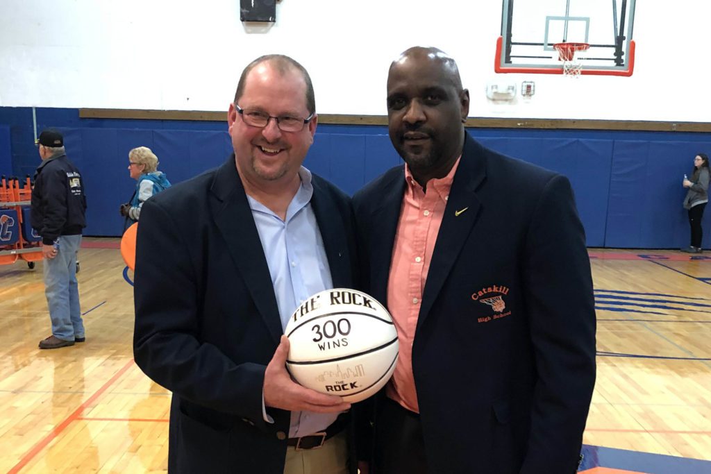 Coach Lampman holding 300 basketball with assistant coach Andy Jones
