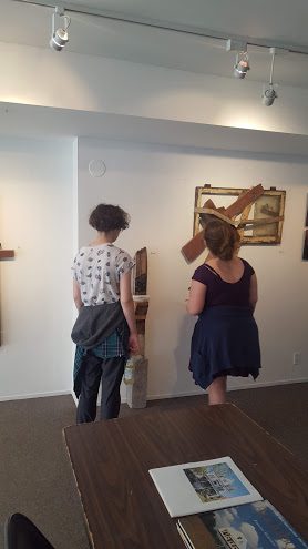 eenagers looking at artwork made from found scrapwood