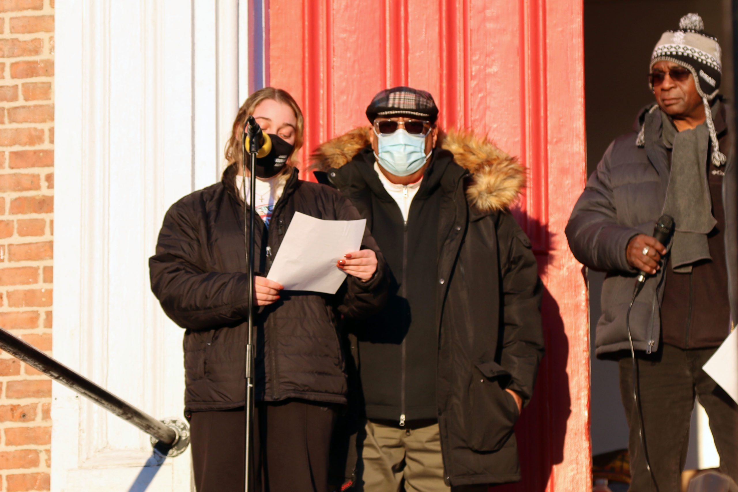 young woman speaking in front of church