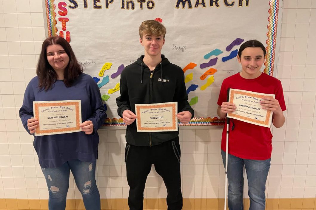 two girls and one boy holding Student of the Month certificates