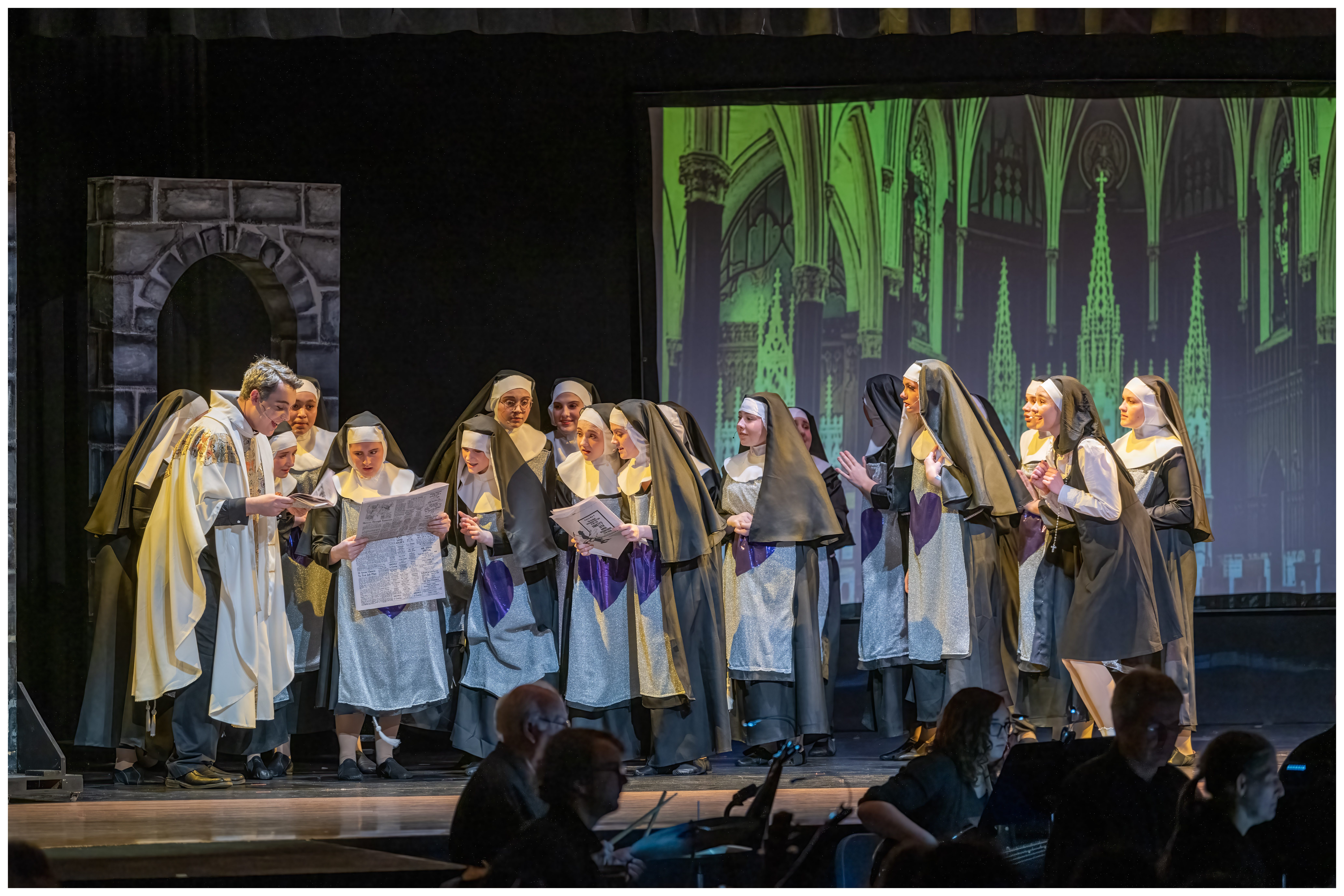 Scene from Sister Act with nuns reading newspaper