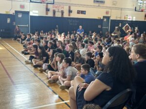 audience of third and fourth graders in CES gym