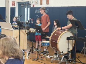 elementary and high school students playing percussion instruments