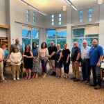 Catskill administrators, Board members and Teacher Association members pose with check in Catskill High School library.