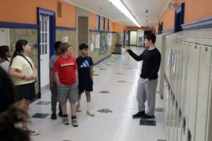 middle school student showing 5th graders a classroom