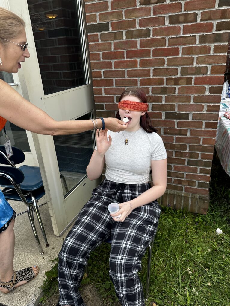 blindfolded girl tasting ice cream