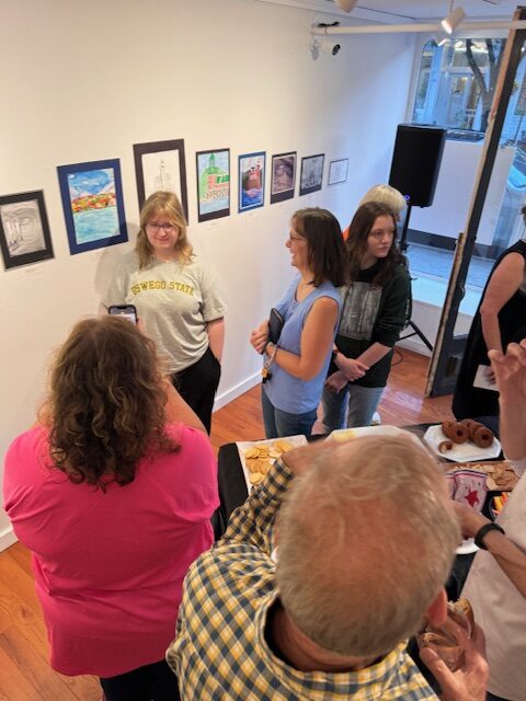 crowd looking at paintings