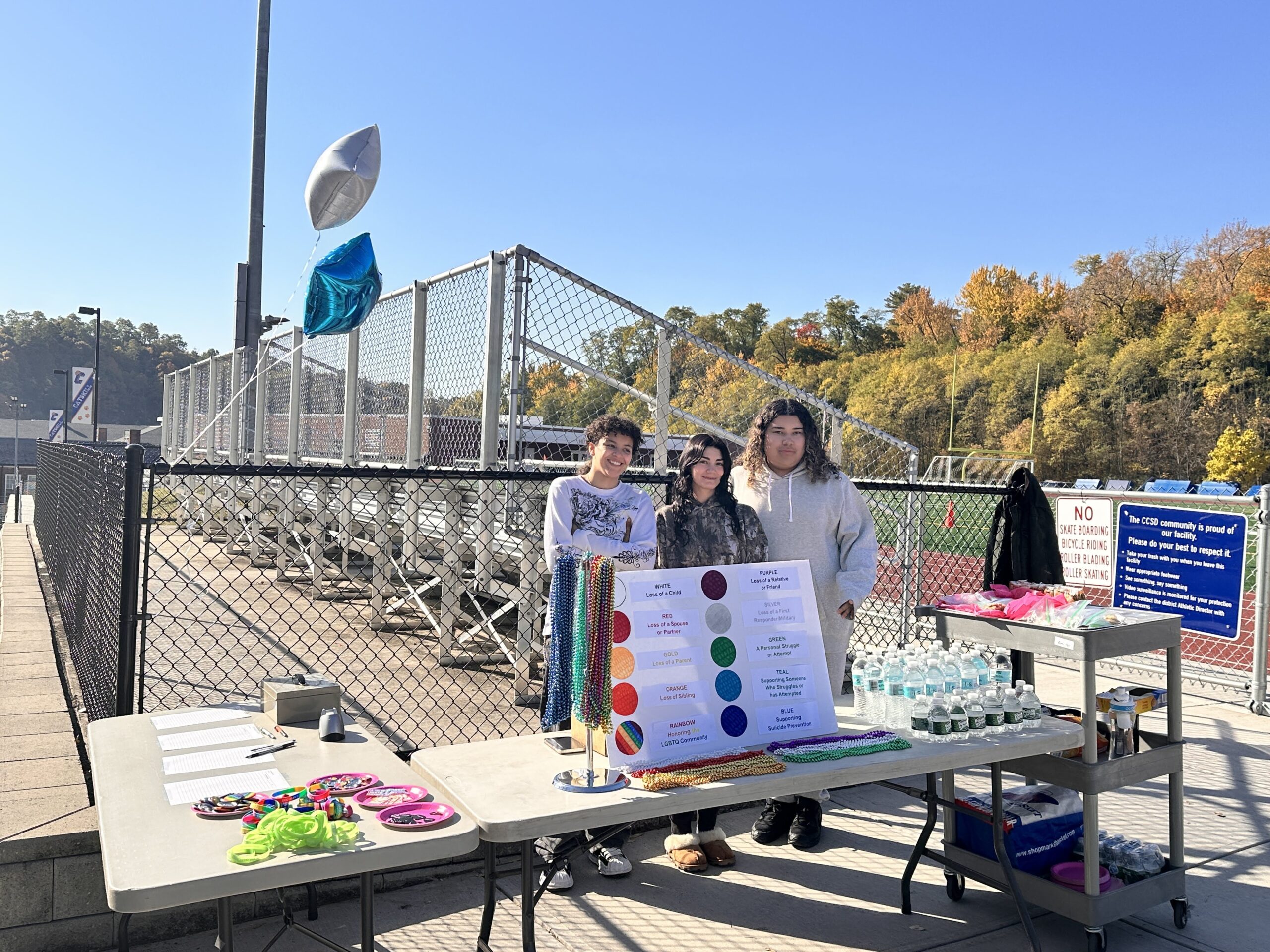 students posing for photo at information booth