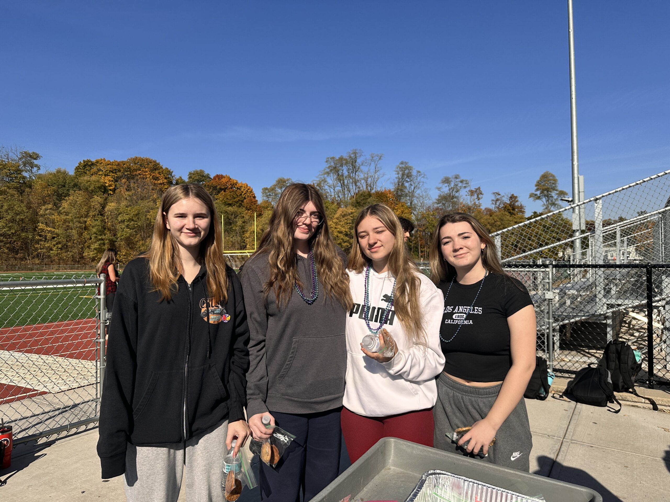 students posing for photo at track