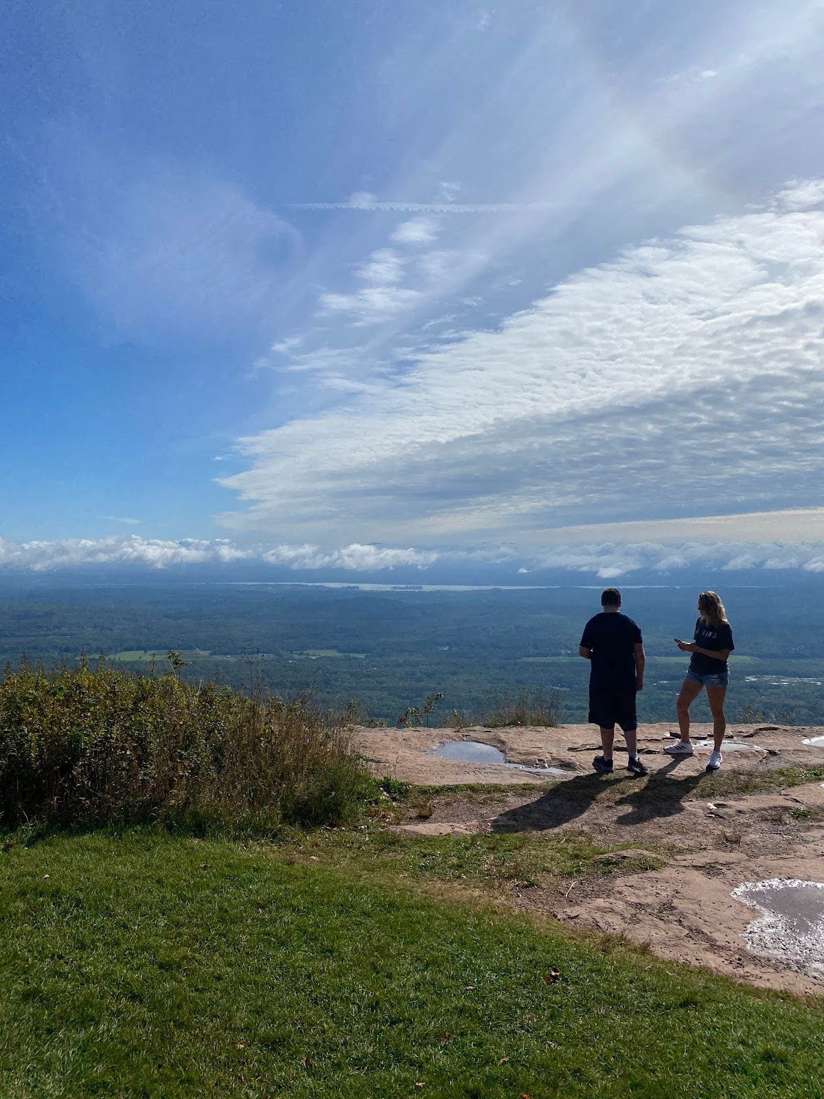 students looking out at view from mountain top