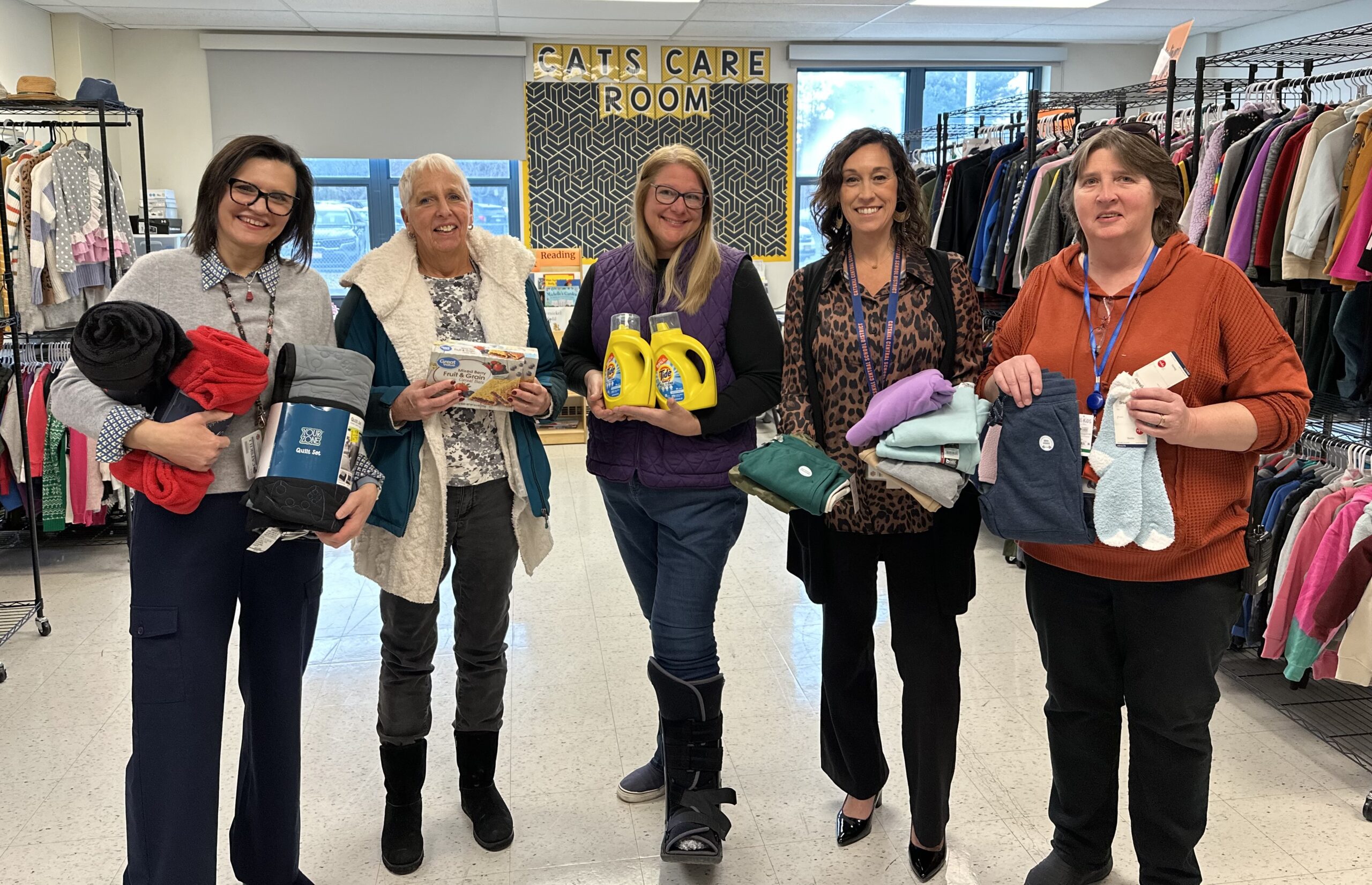 five women posing with boxes of supplies