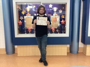 boy holding certificate