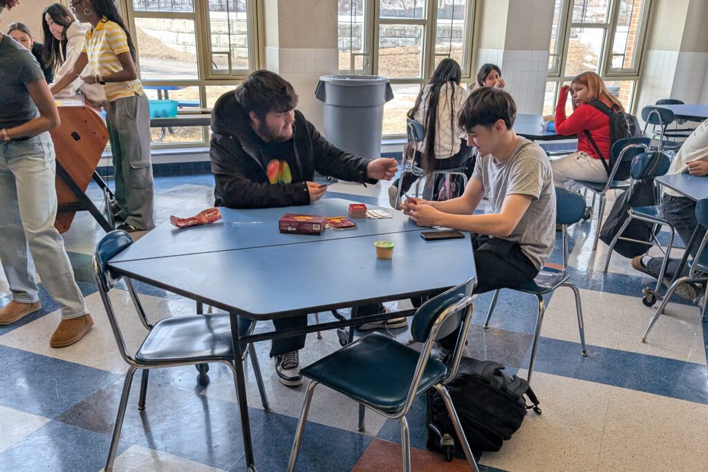 students playing cards at table