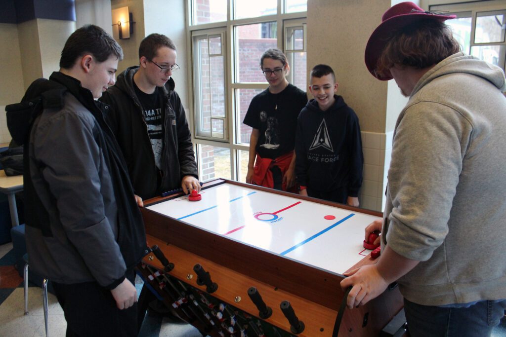 students playing air hockey