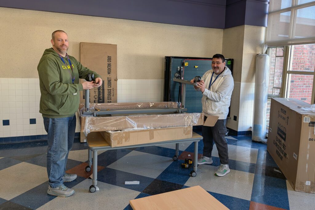 two men assembling furniture