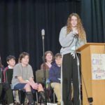 Girl spelling at Podium.
