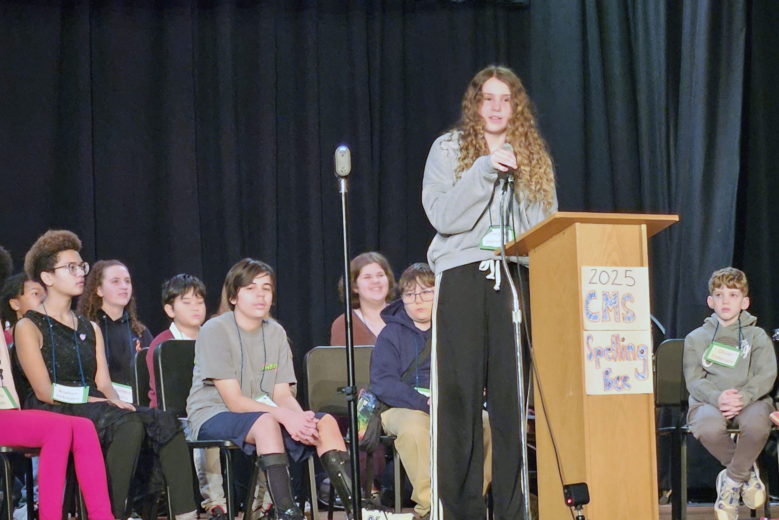 Girl spelling at Podium.