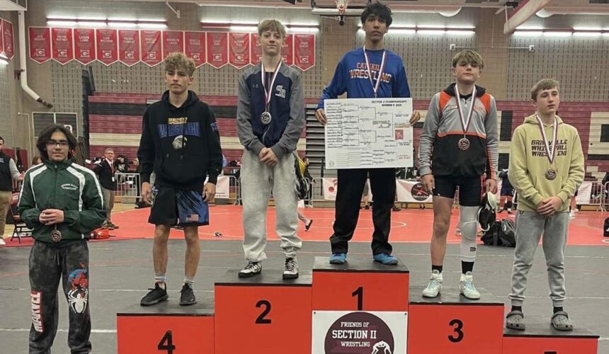 wrestlers standing on podium