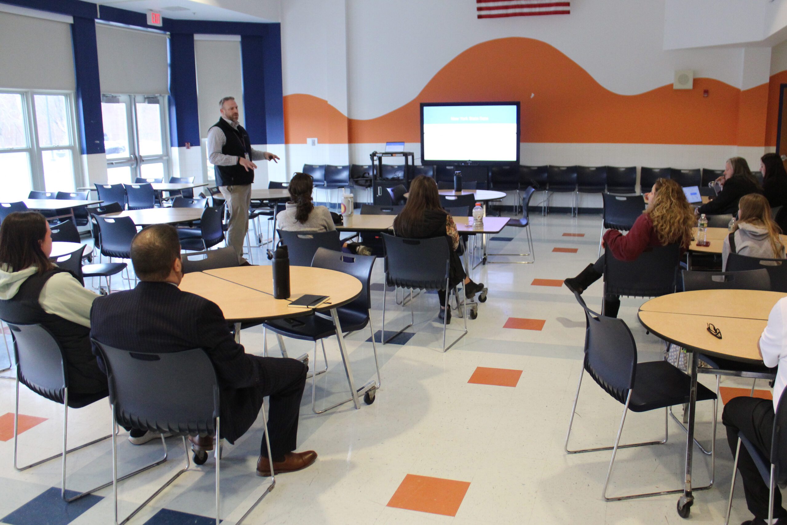 Dr. Dan speaking to group of parents seated in cafeteria
