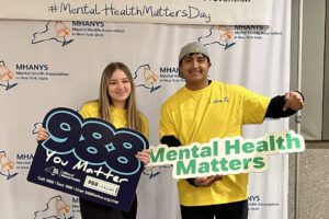 students pose with mental health matters and 988 You Matter signs