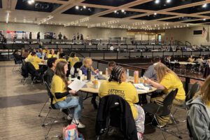 students seated at Empire Plaza convention centert