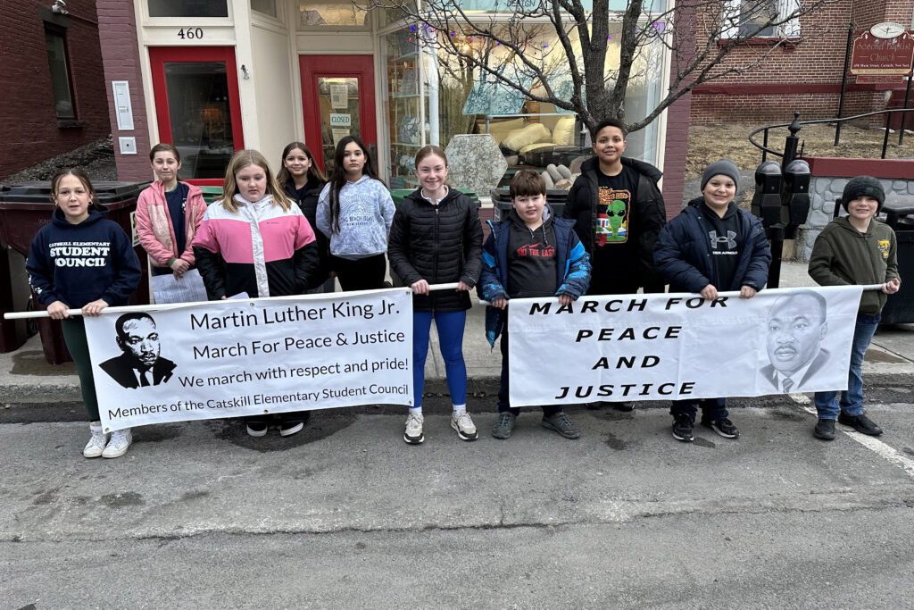 students holding Martin Luther King Jr. Banner and March for Peace and Justice banner