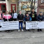 students holding Martin Luther King Jr. Banner and March for Peace and Justice banner