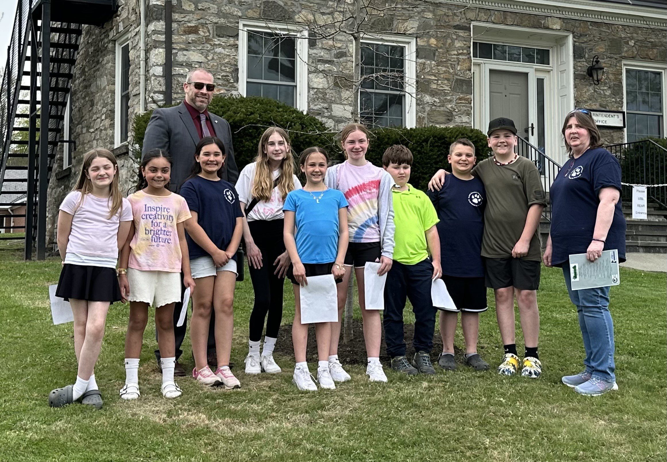 CES Student Council poses with newly planted tree and superintendent Dan Wilson