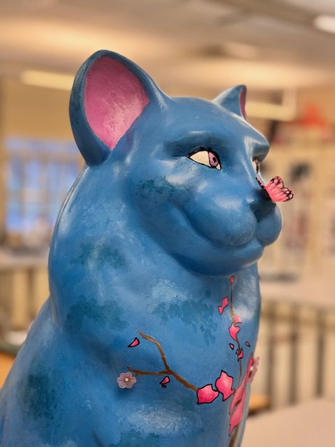 cat sculpture with 3-d butterfly on its nose