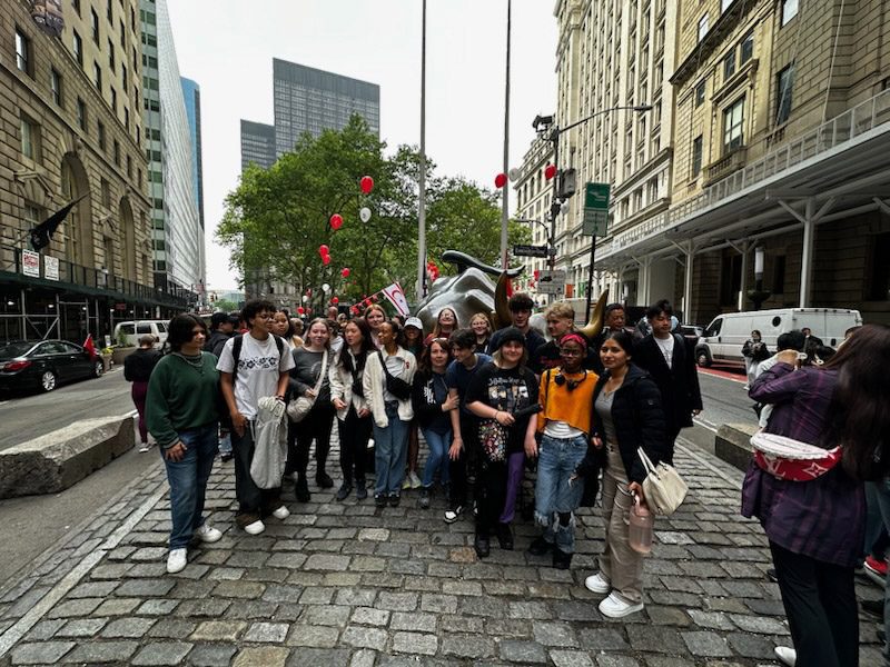 group shot of students with Bull statue