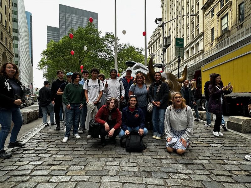 group shot of students with Bull statue