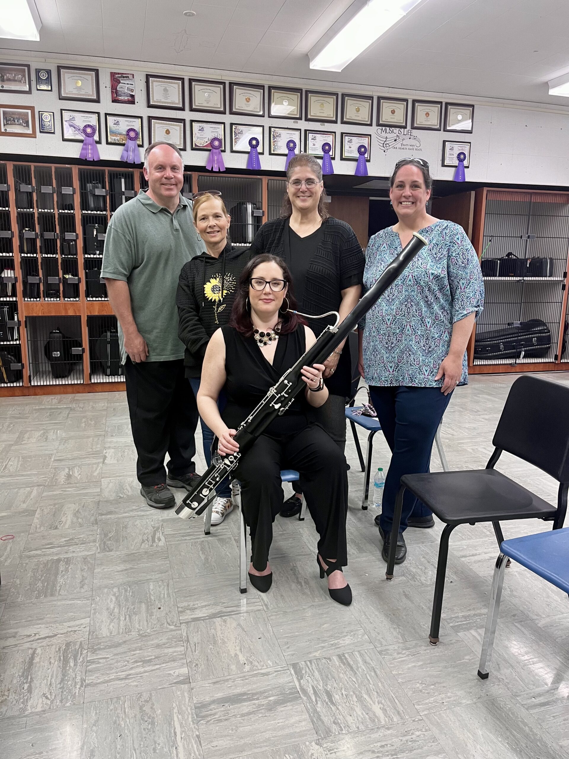 Group of adults holding bassoon
