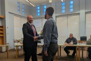 teacher shaking hands with superintendent