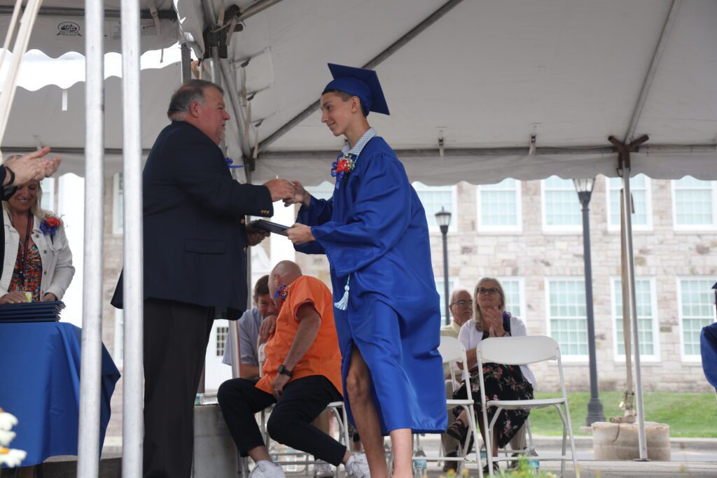 graduate shaking hands with board president