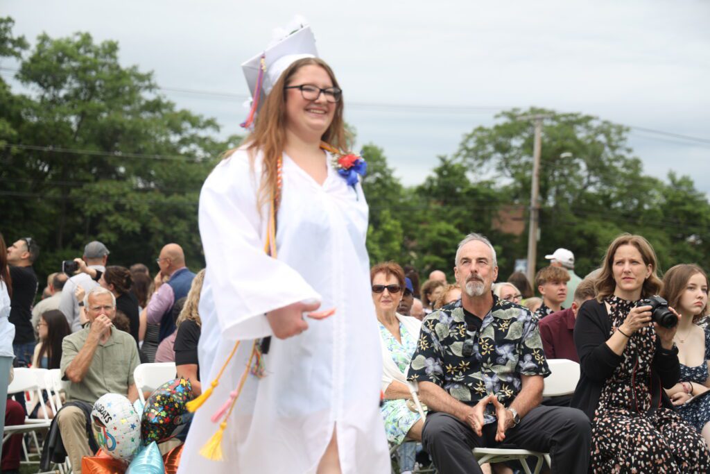 graduate walking down isle