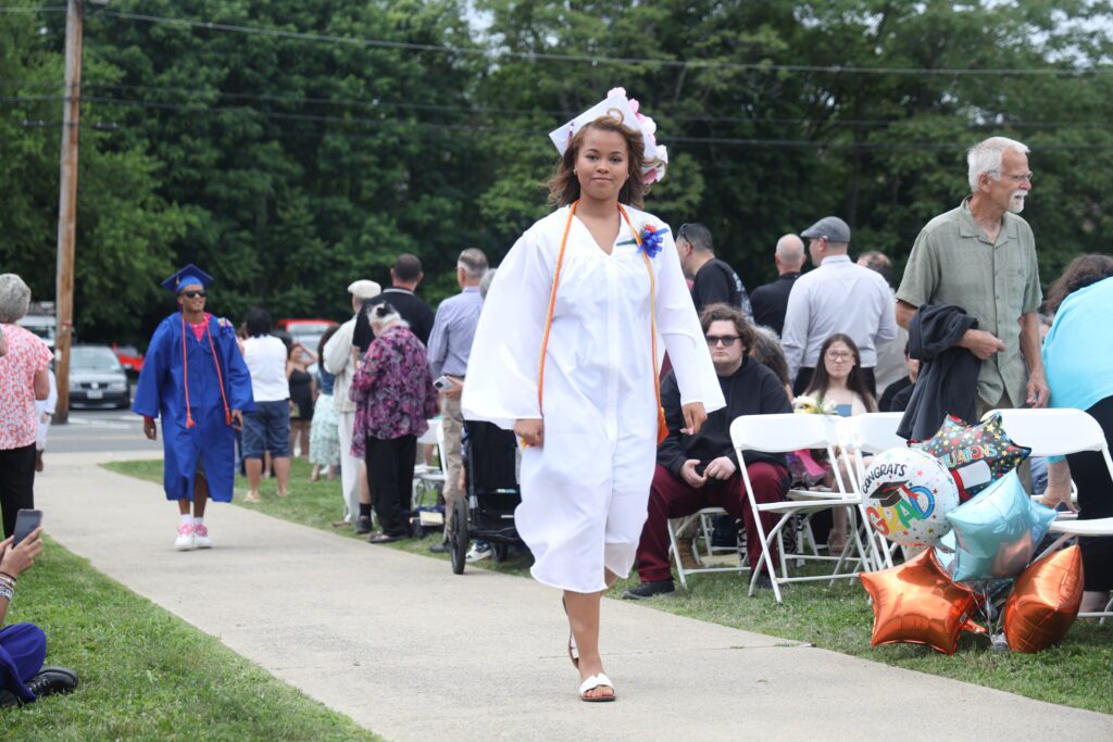 graduate walking down isle