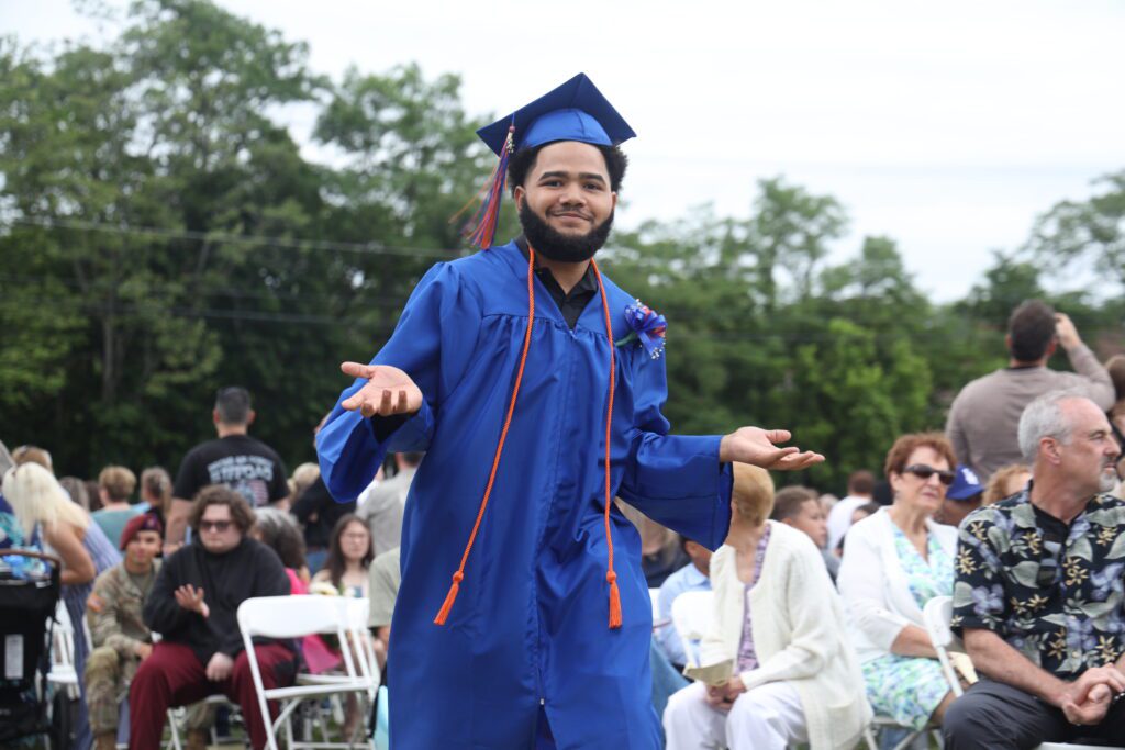 graduate walking down isle
