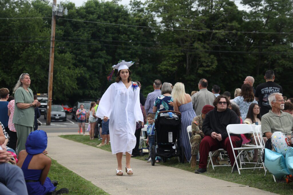 graduate walking down isle