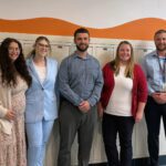 five teachers pose for group photo