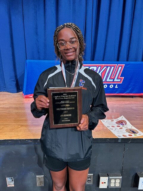 Ava Edmond holding award plaque