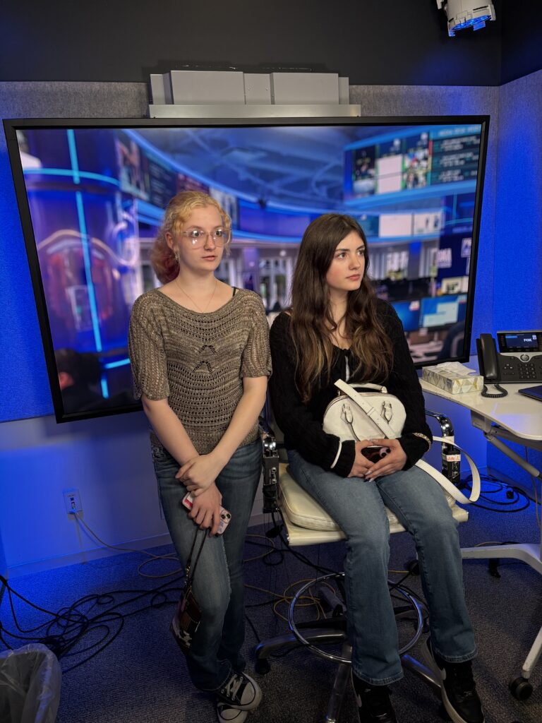 two girls sitting on news desk