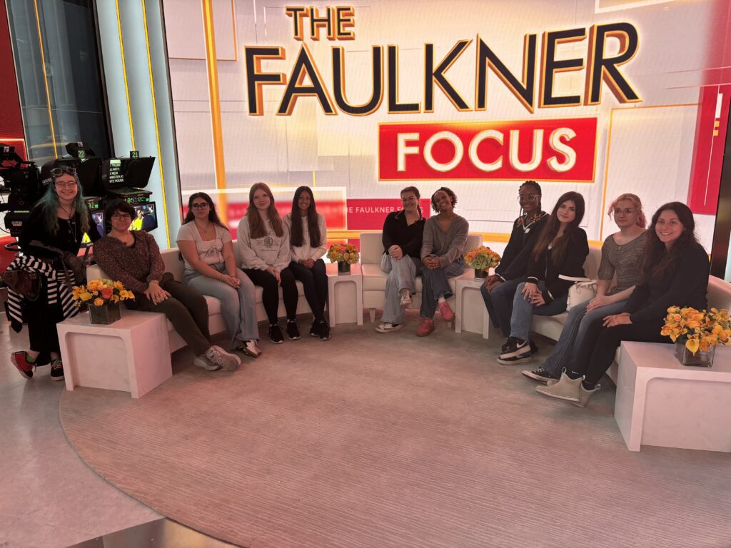 group photo of girls sitting on Faulkner Focus set