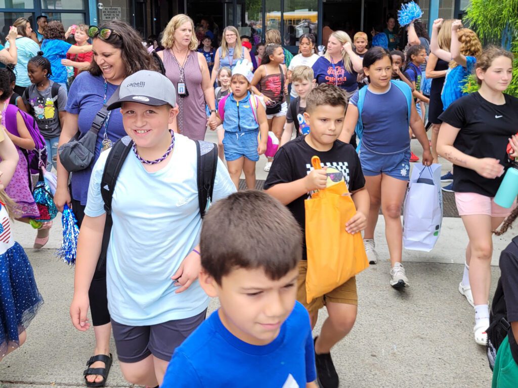 crowd of students exiting school building