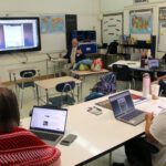 man giving presentation to faculty in classroom