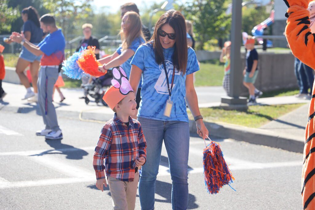 teacher and boy walking in parade