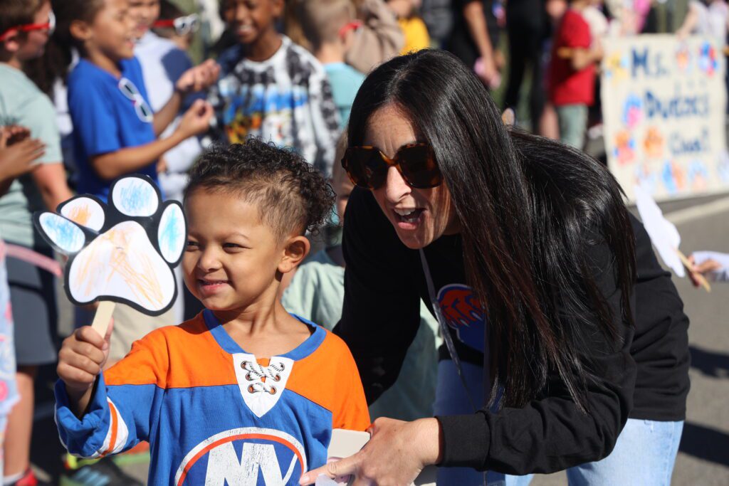 teacher and girl posing for photo